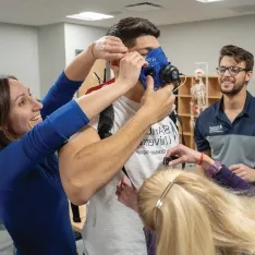 Kinesiology students conducting an assessment in a lab setting.